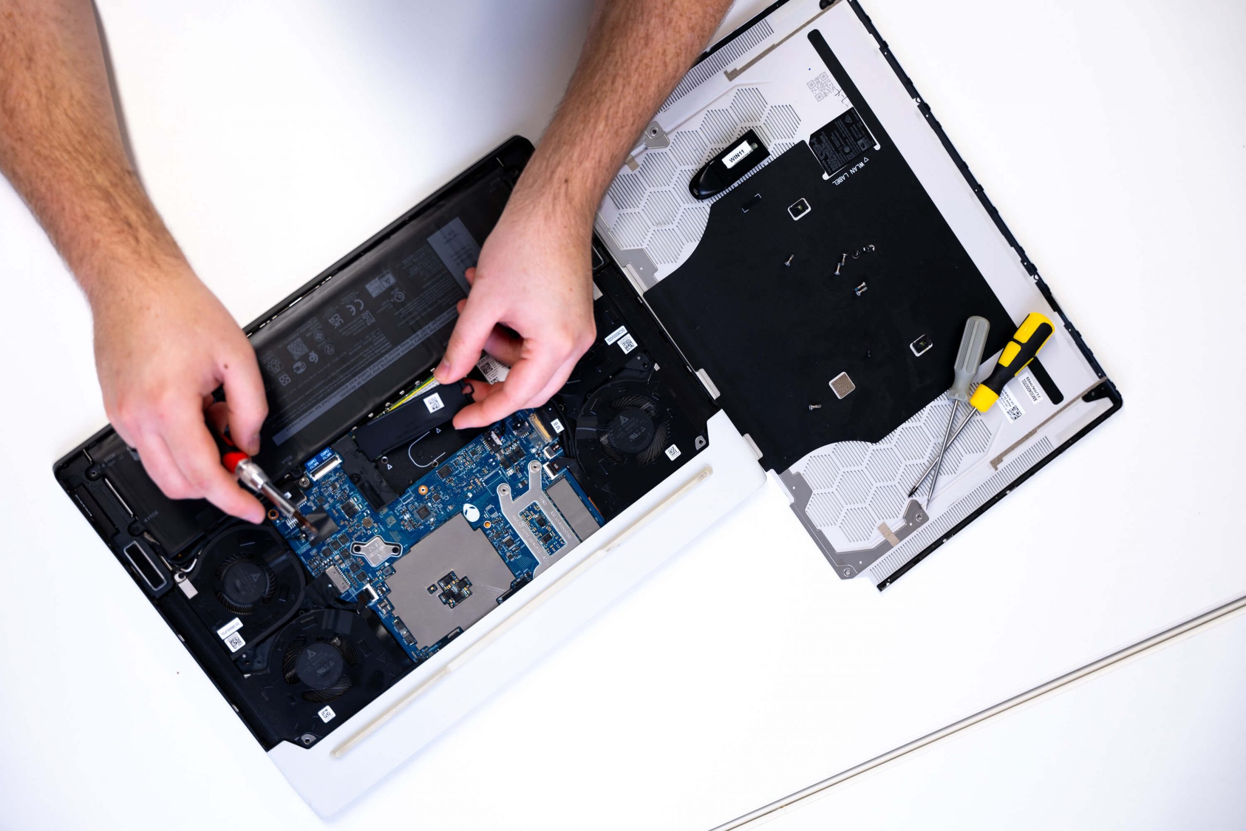 IT technician performing a laptop hardware upgrade and repair at Bluebell IT Solutions