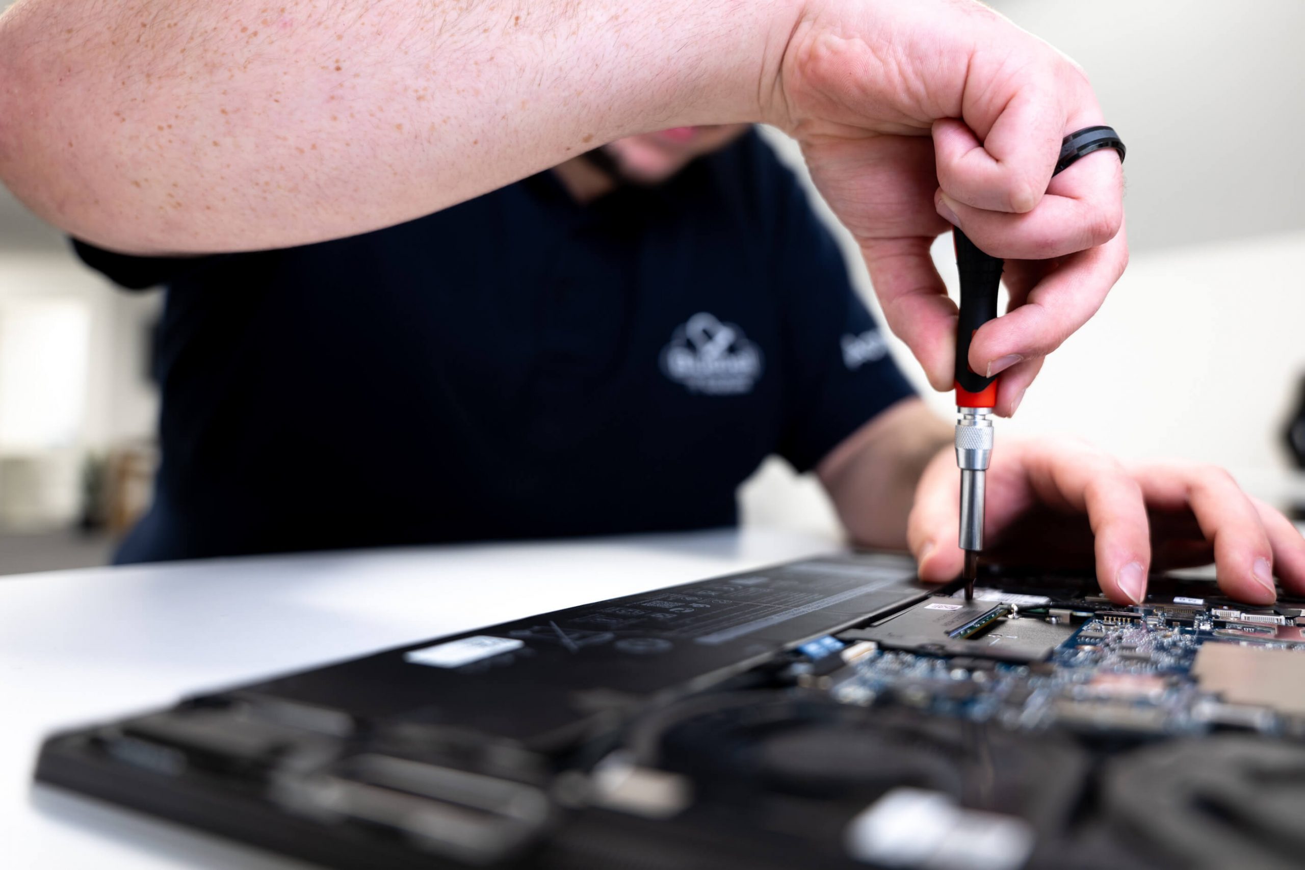 IT technician repairing a laptop motherboard at Bluebell IT Solutions hardware support service